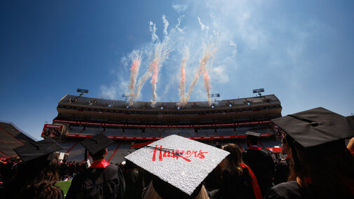 Graduate cap reflects sun during commencement at Memorial Stadium