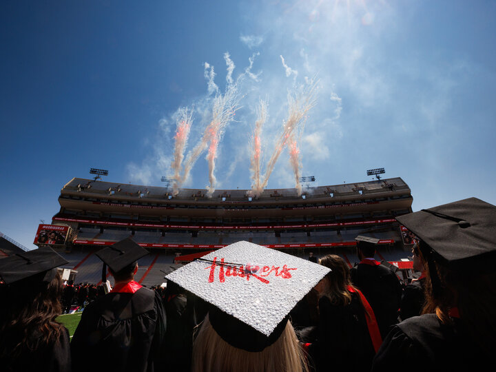 Graduate cap reflects sun during commencement at Memorial Stadium