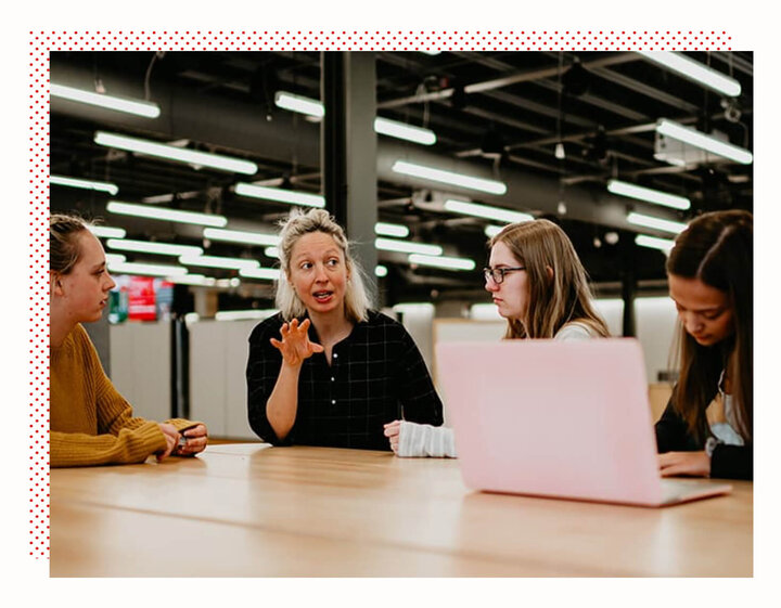 Image of students and teachers talking around a laptop with dotted style applied